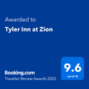 A blue sign that says ' awarded to tyler inn at zion ' on it