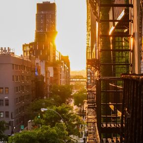 The sun is shining brightly on the buildings in the city