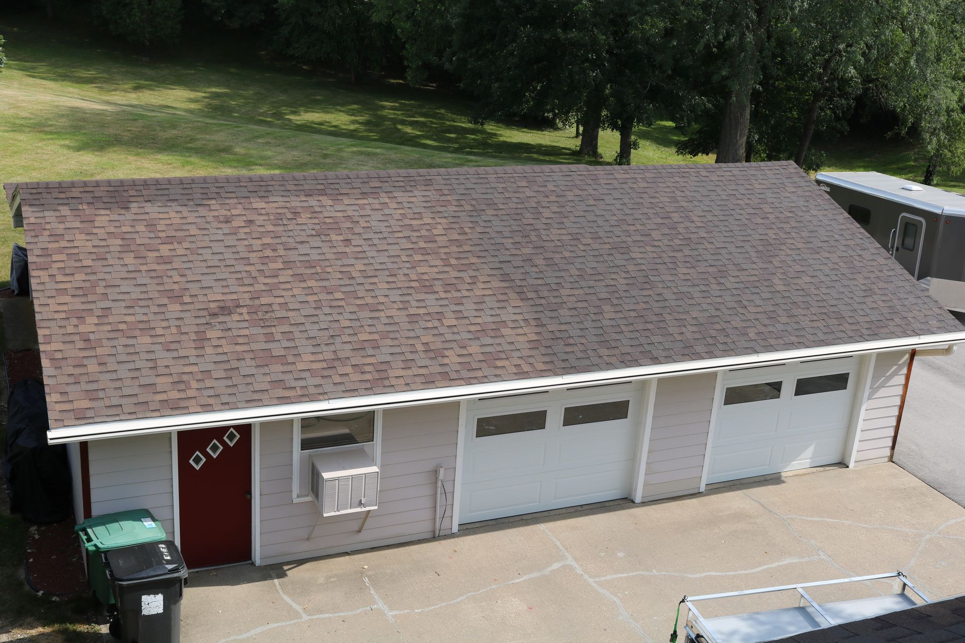 An aerial view of a garage with a brown roof.