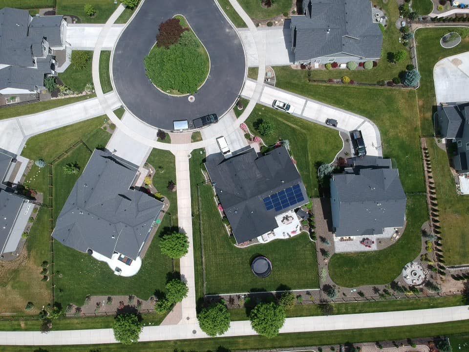 An aerial view of a residential neighborhood with a circle in the middle