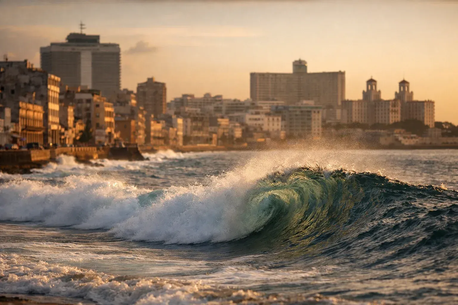 Golden-hour wave crashing along Havana’s Malecón with city
