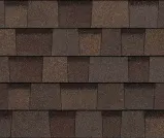 A close-up view of dark brown architectural asphalt roofing shingles with a textured, layered pattern.