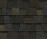 A repeating pattern of dark gray and black architectural asphalt roof shingles with a textured, layered appearance.