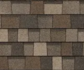 A repeating, seamless pattern of architectural roof shingles in shades of brown, tan, and charcoal gray.
