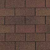 A repeating pattern of dark brown, rectangular architectural roofing shingles.