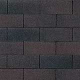 A close-up, top-down view of dark gray, rectangular asphalt shingles arranged in a standard offset brick pattern.