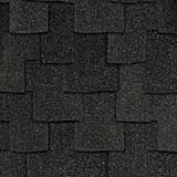 A close-up, top-down view of black, rectangular architectural roof shingles layered in a repeating, staggered pattern.
