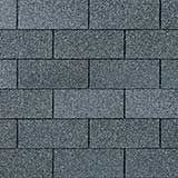 A texture of grey, rectangular asphalt shingles arranged in an overlapping, staggered brick-like pattern.