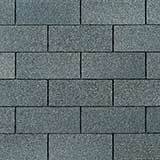 Dark gray, rectangular roof shingles arranged in a standard offset, running bond pattern.