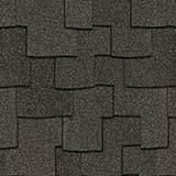 A close-up of overlapping dark gray asphalt roof shingles with a textured, layered pattern.
