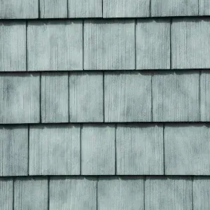 Light blueish-gray rectangular shingles arranged in a repeating horizontal pattern on a wall or roof.