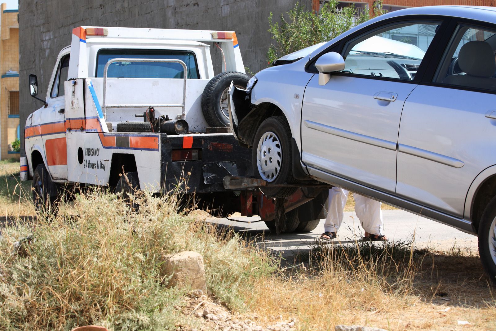 A car is being towed by a tow truck