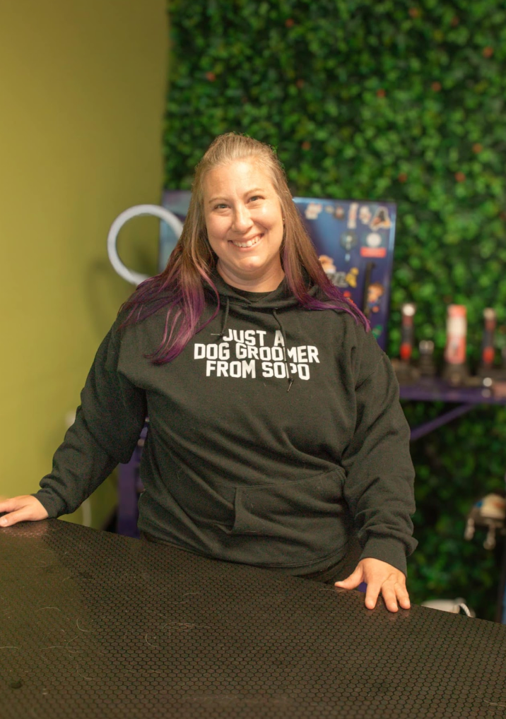 A woman is sitting at a table with her hands on the table.