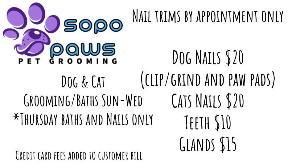 A sign for sopo paws pet grooming shows the prices for dog and cat grooming