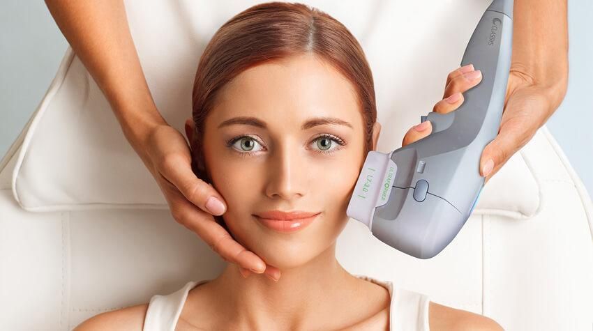 A woman is getting a facial treatment at a beauty salon.