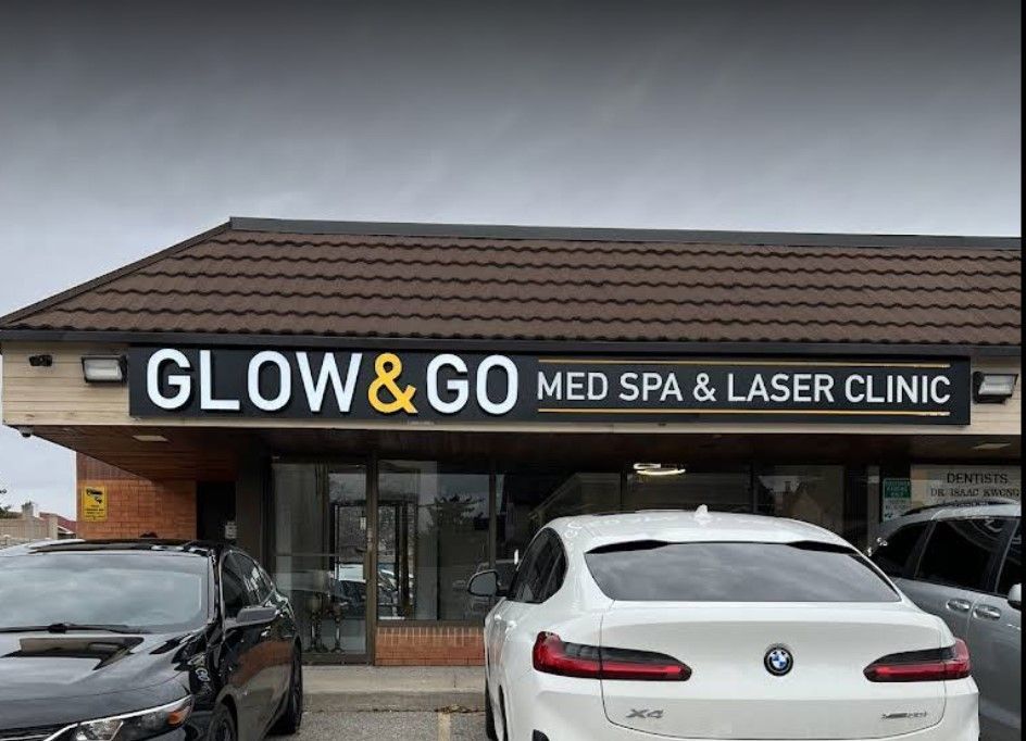 A white car is parked in front of a building that says glow & go med spa & laser clinic.