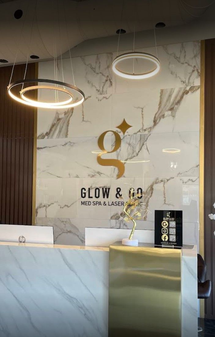 A marble reception desk with a sign that says glow & hd