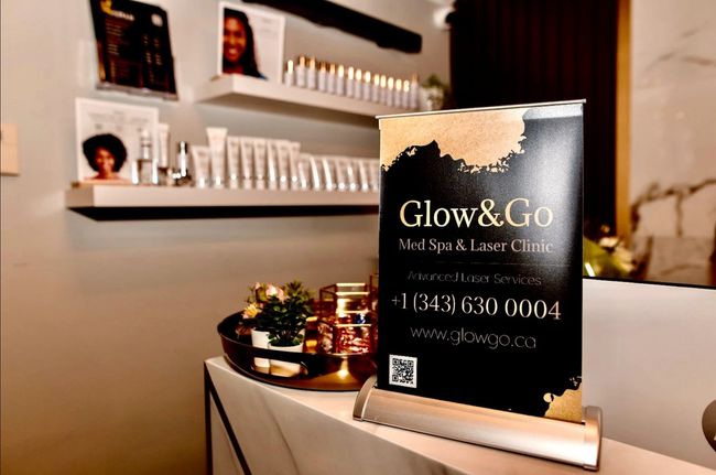 A sign for glow & go is sitting on a counter in a salon.
