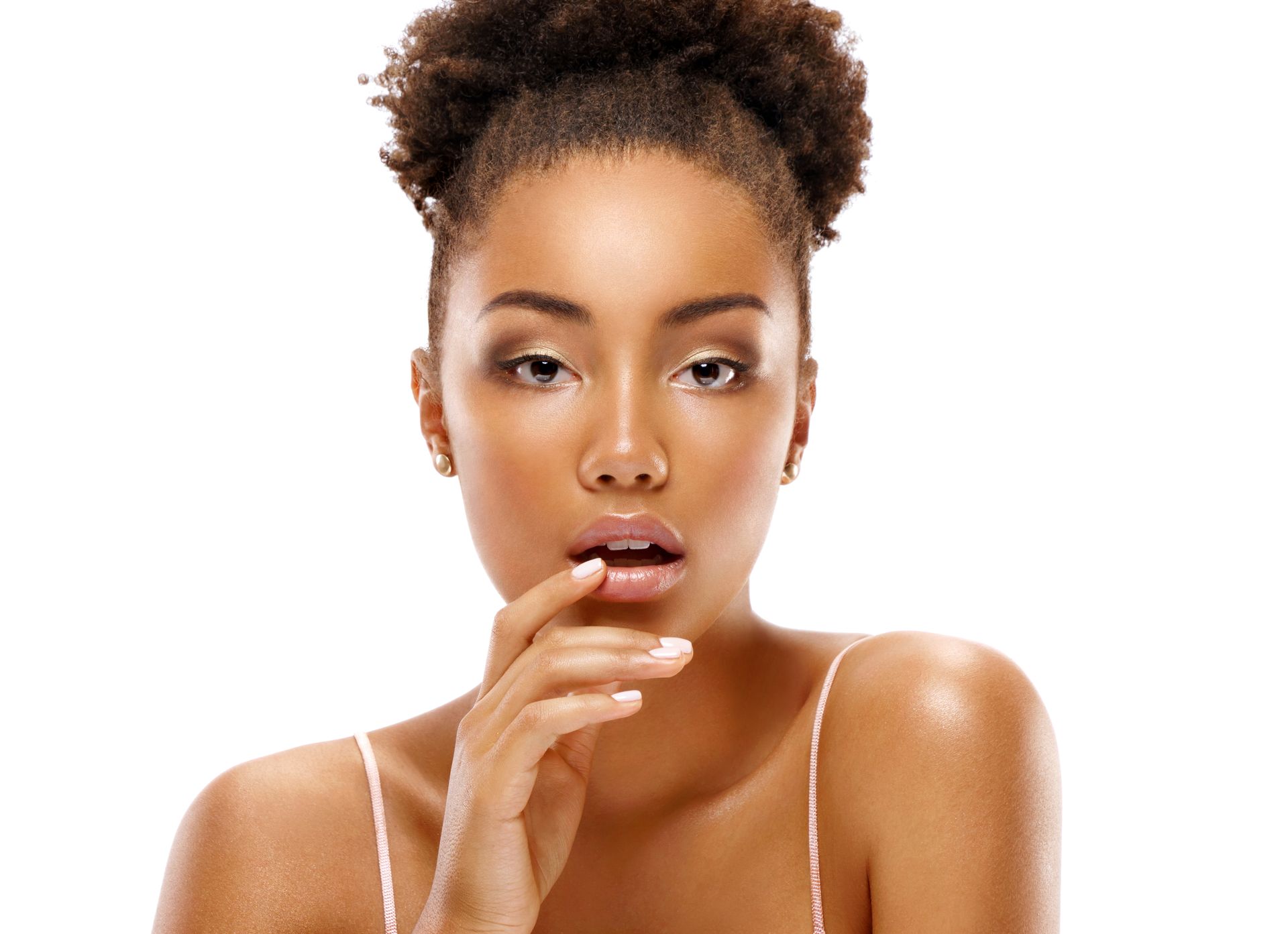 A woman is applying lip balm to her lips.