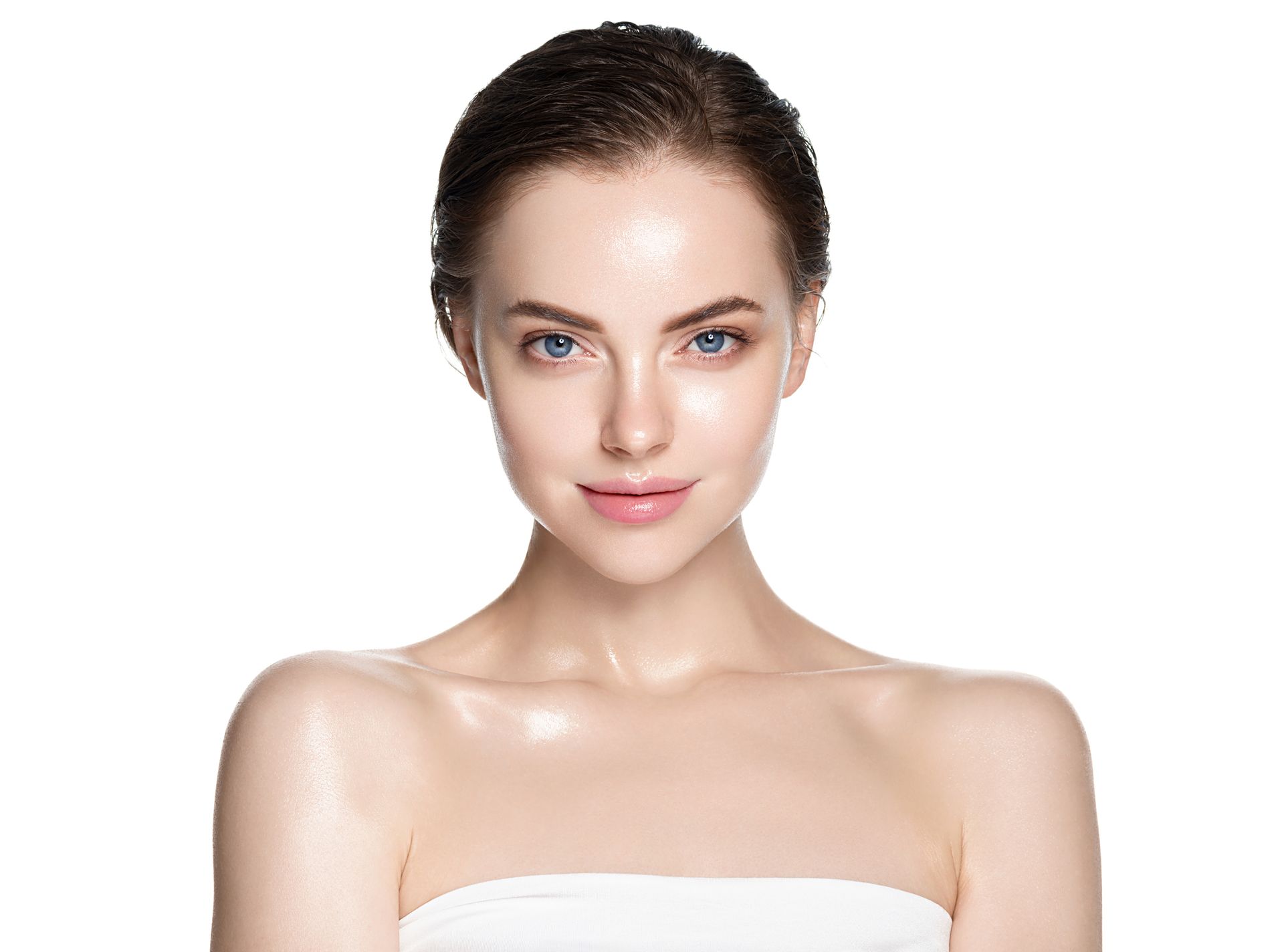 A woman with a towel wrapped around her shoulders is looking at the camera.