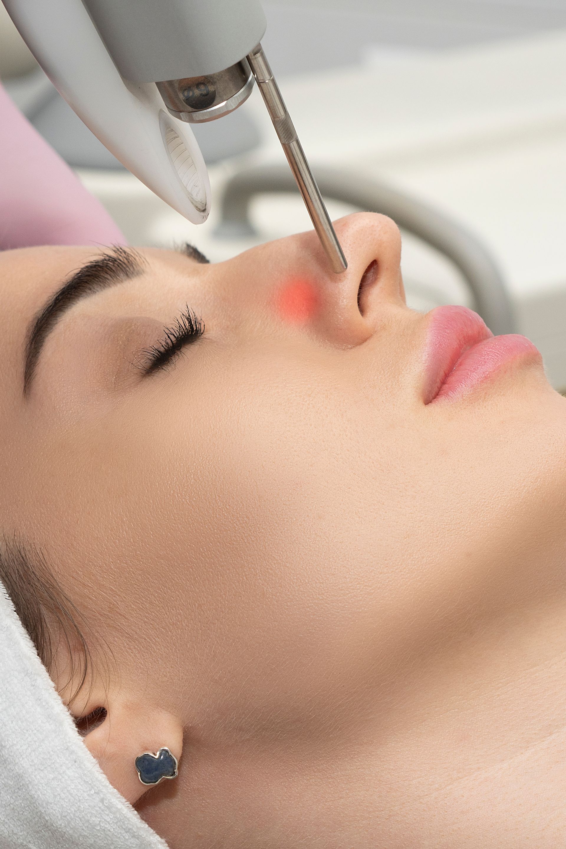 A woman is getting a facial treatment at a beauty salon.
