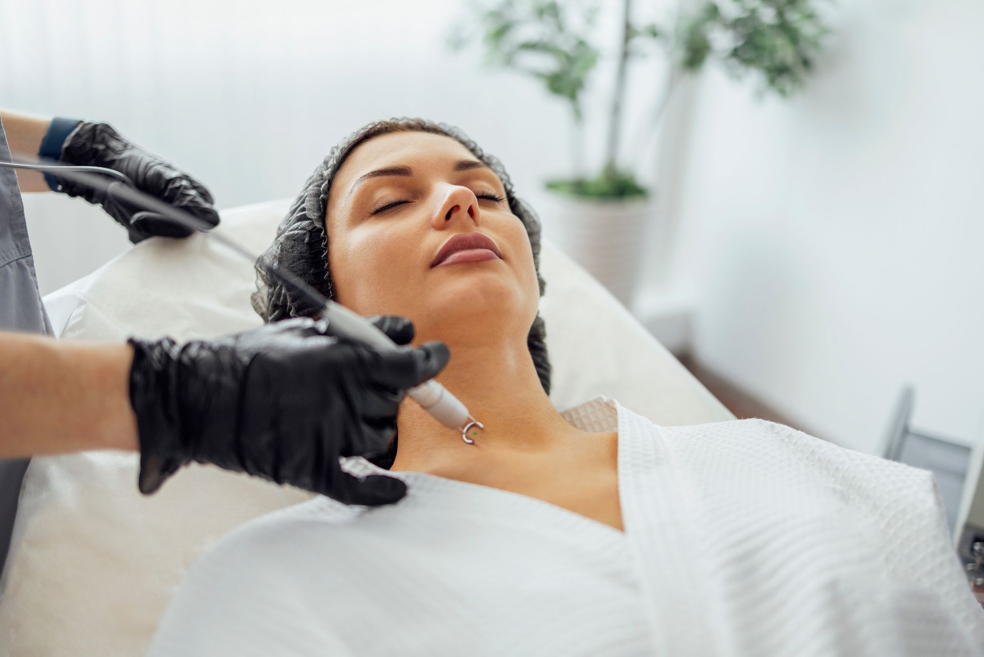 A woman is getting a facial treatment at a beauty salon.