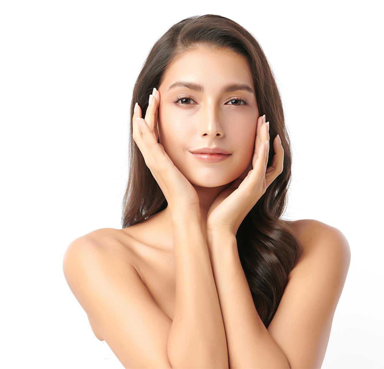 A woman is touching her face with her hands and smiling.
