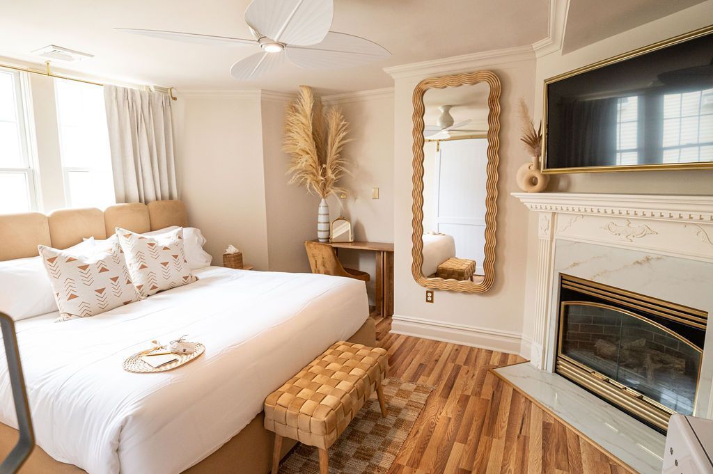 A bed with white sheets and a book on it.