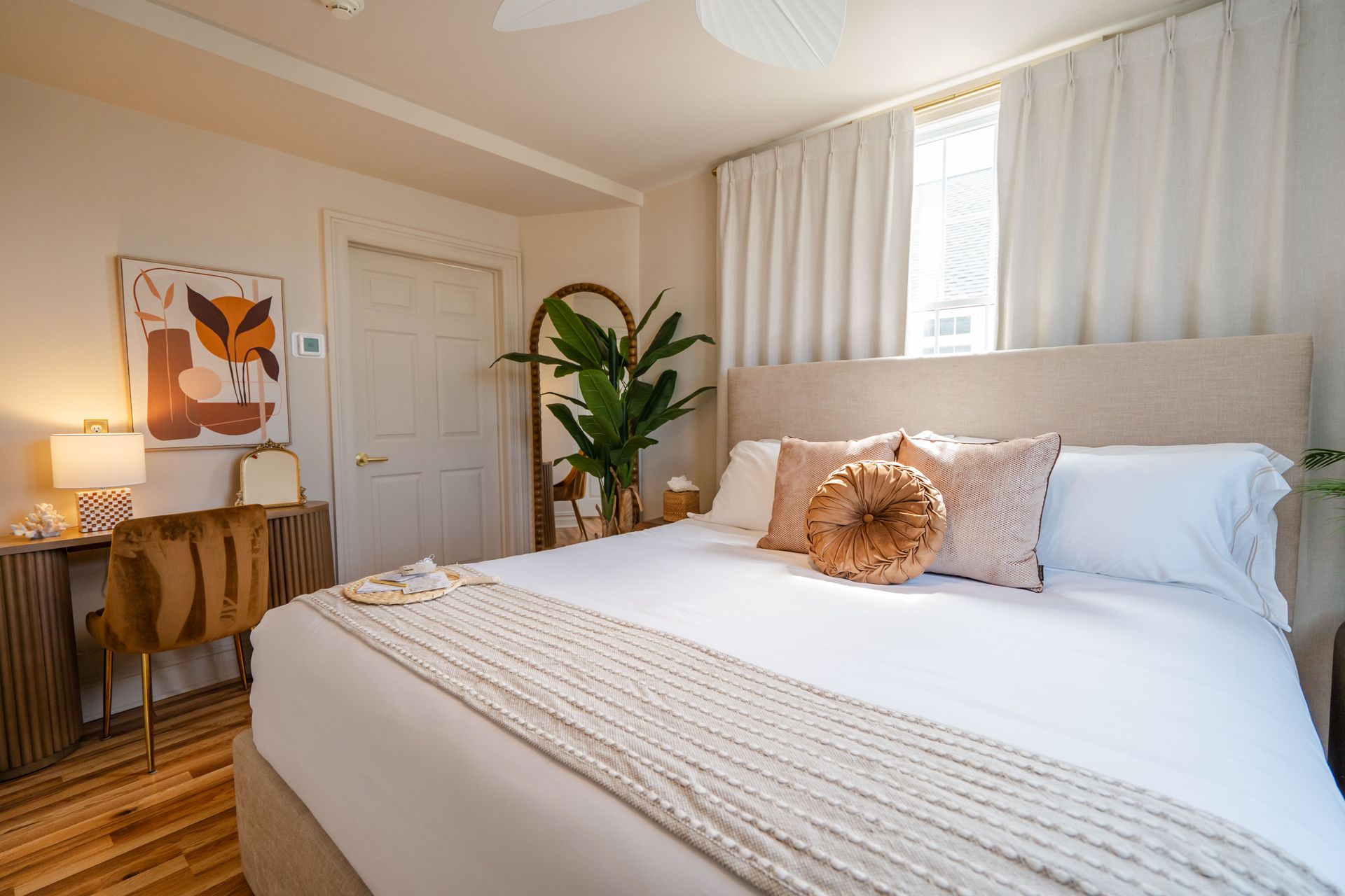 A bed with white sheets and a book on it.