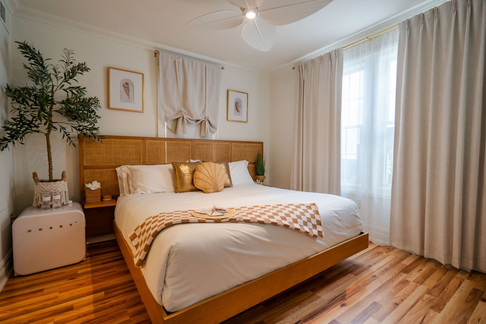 A bed with white sheets and a book on it.