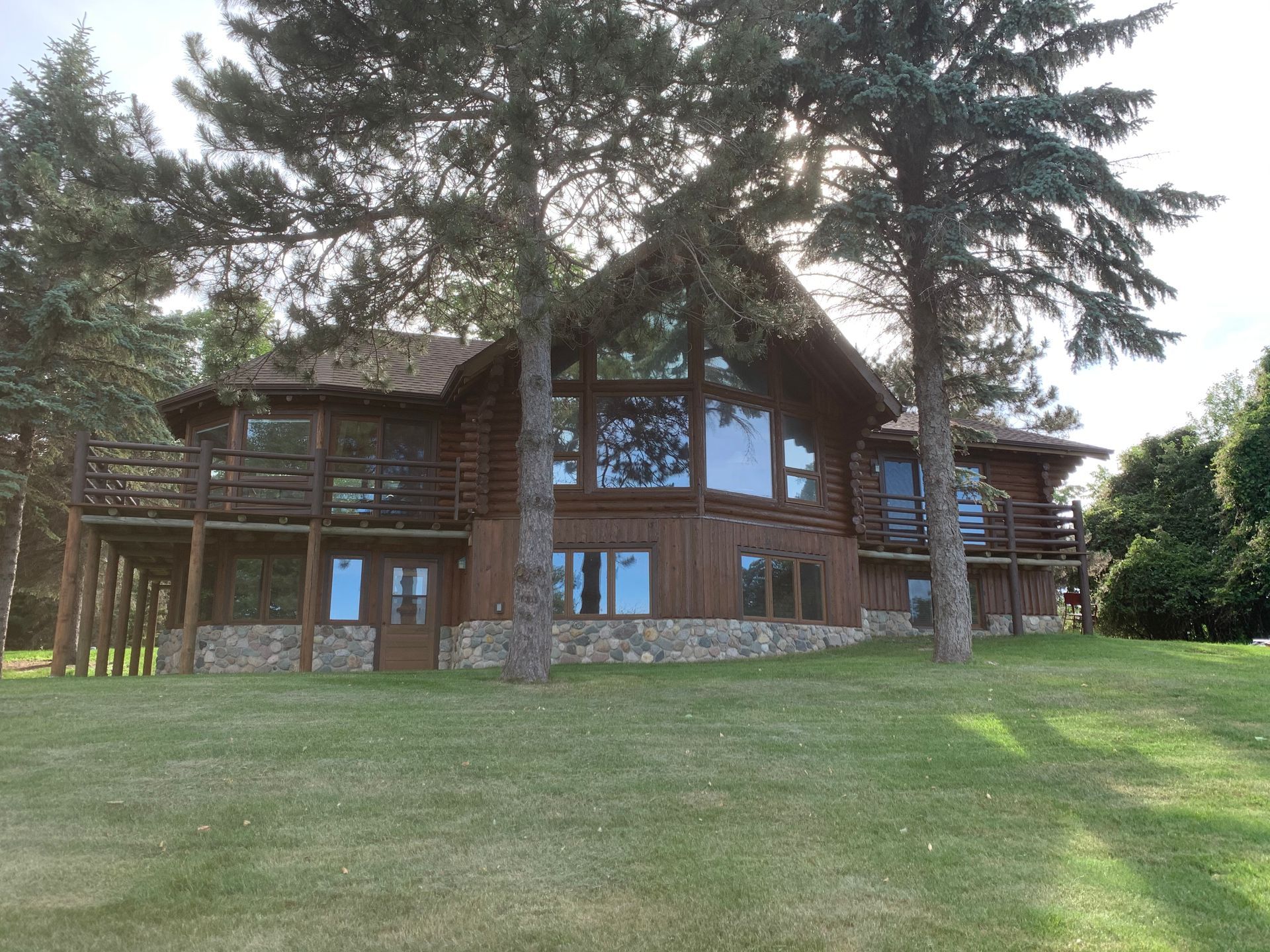 A Large Log Cabin With Glass Windows – MN - Lifetime Staining and Log Restoration