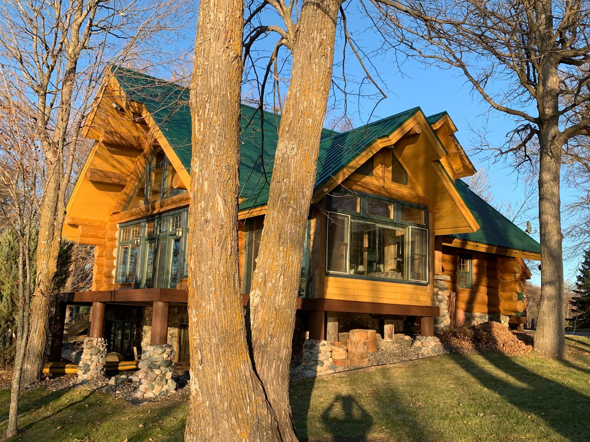 Cabin With a Green Roof – MN - Lifetime Staining and Log Restoration