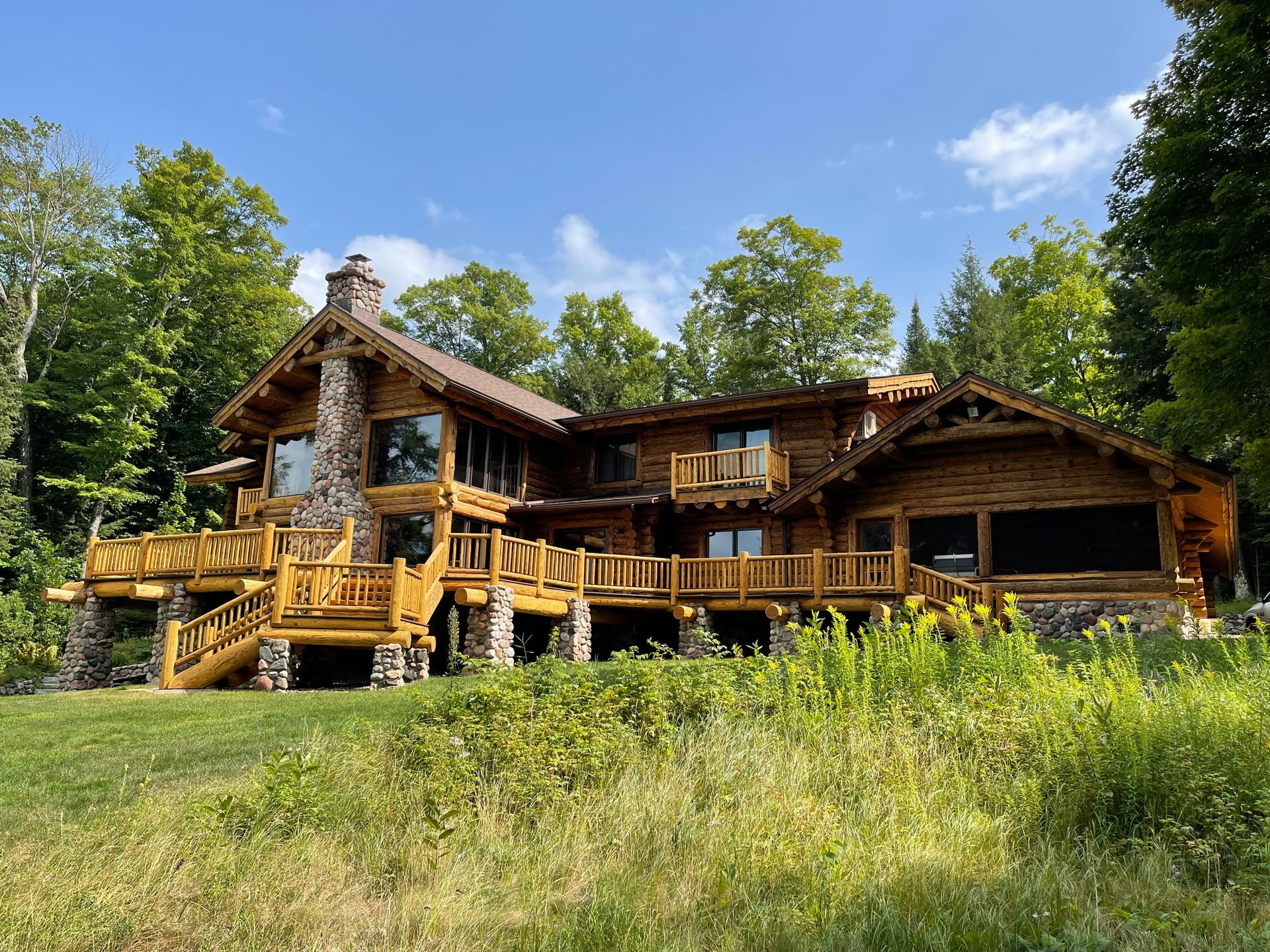 A Large Log Cabin in a Forest – MN - Lifetime Staining and Log Restoration