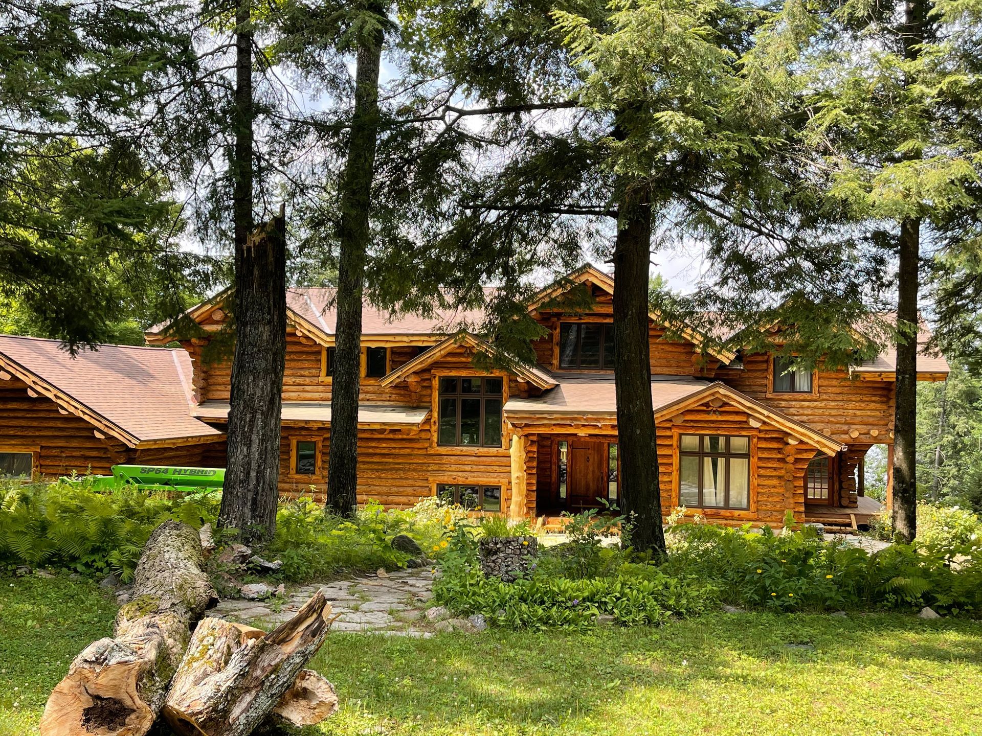 Large Log Cabin is Surrounded by Tree – MN - Lifetime Staining and Log Restoration