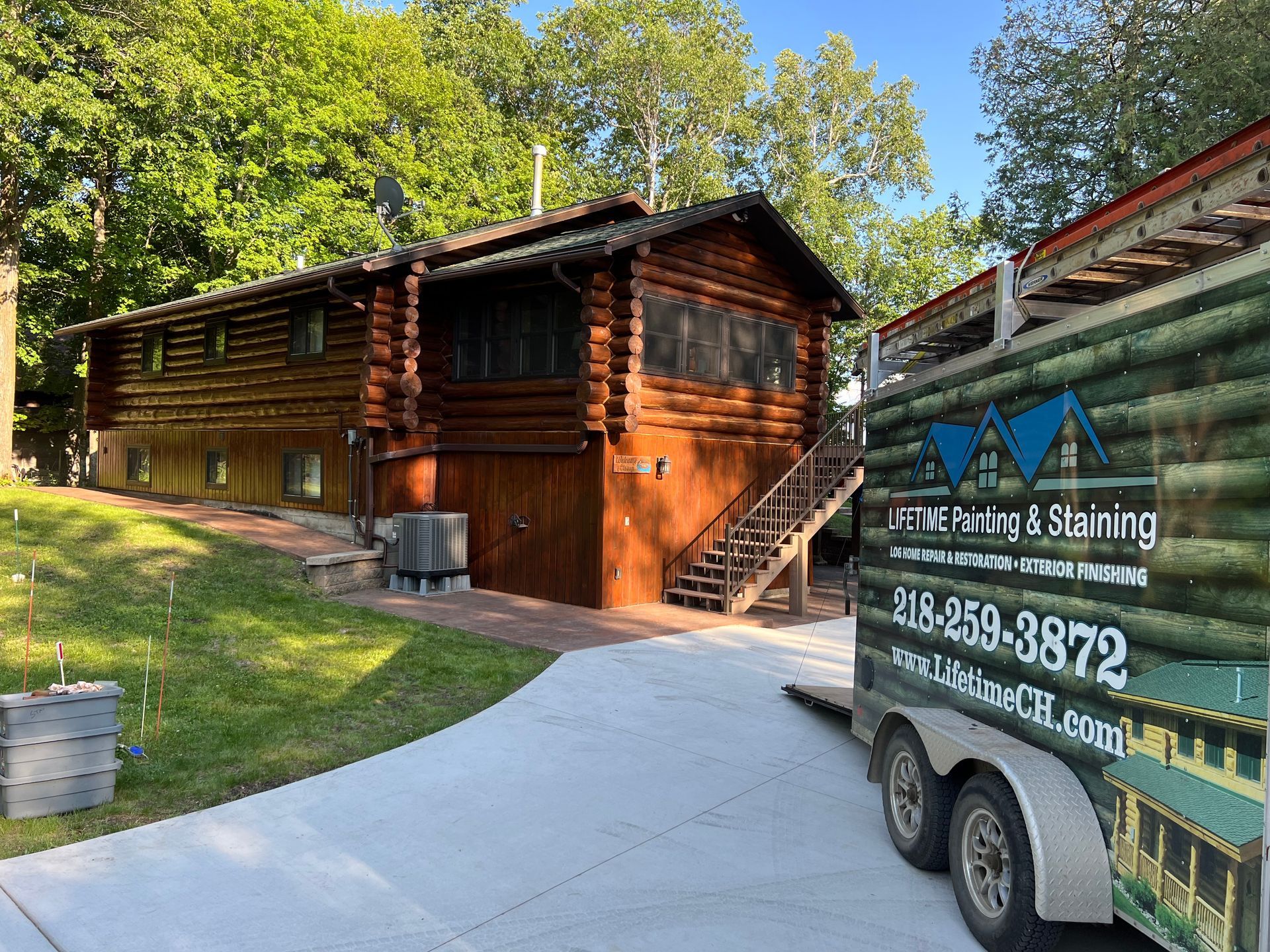 A Truck is Parked in Front of Cabin – MN - Lifetime Staining and Log Restoration