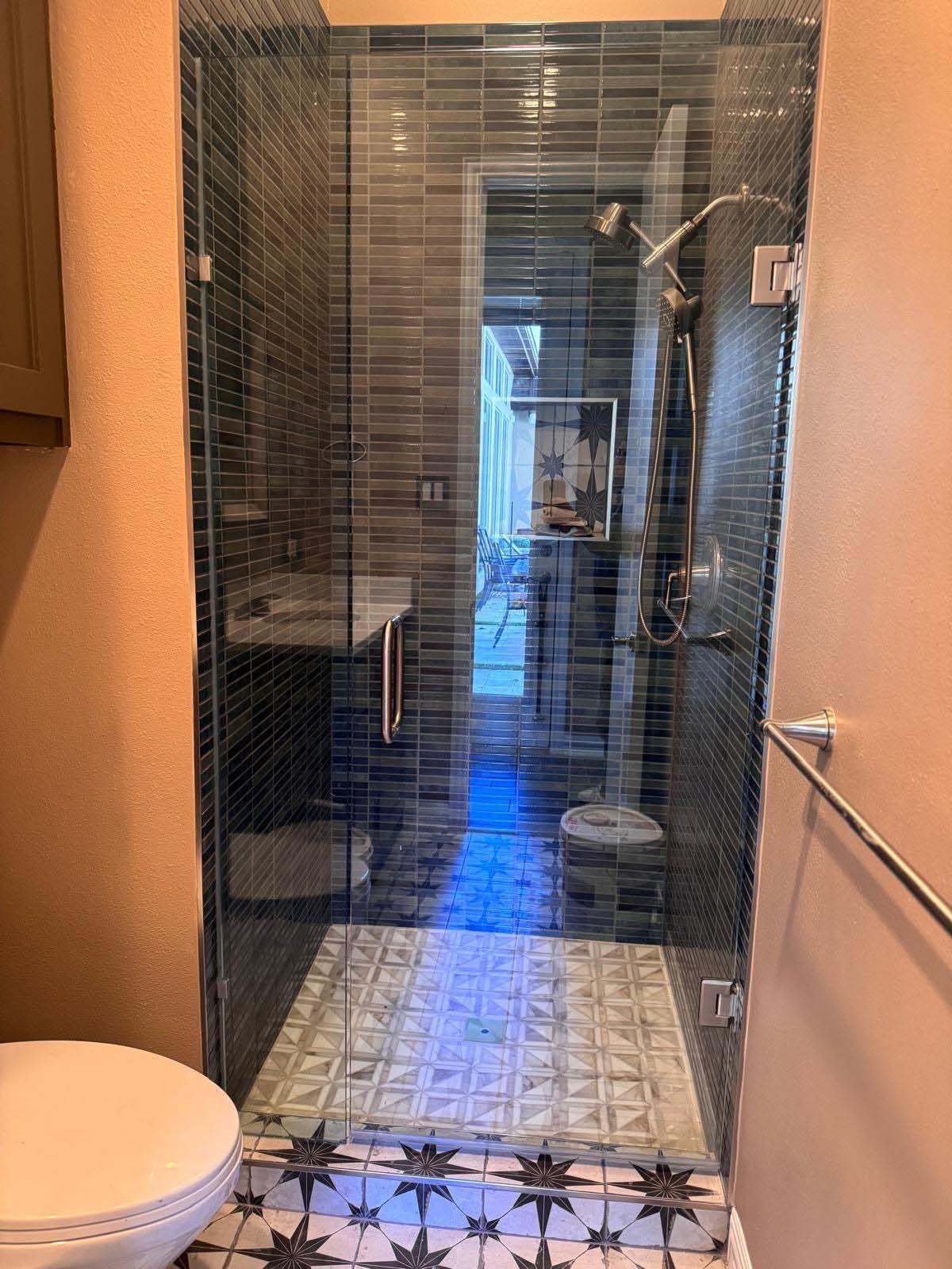 A bathroom with a walk-in shower and a toilet