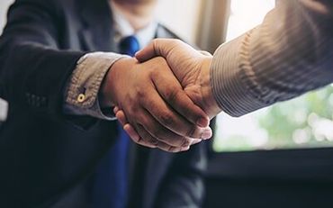 Two men handshaking — Environmental Branding in Stetson, ME