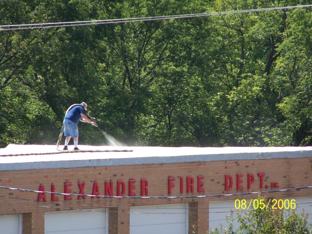 A man is cleaning the roof of the alexander fire department