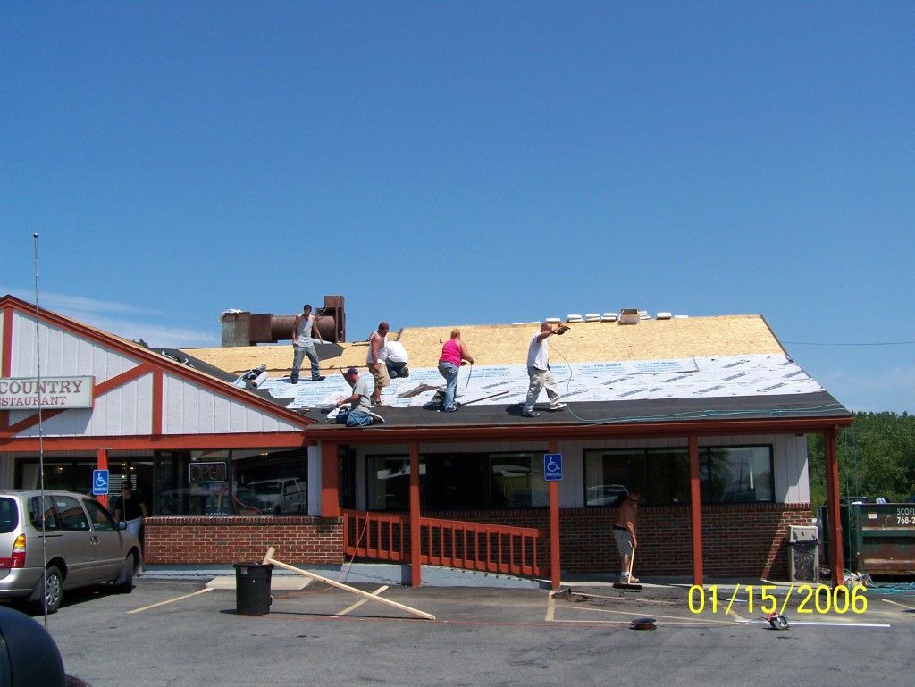 A group of people are working on the roof of a building