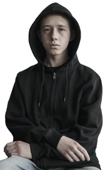 Teen in black hooded sweatshirt, looking at the camera, against a white background.