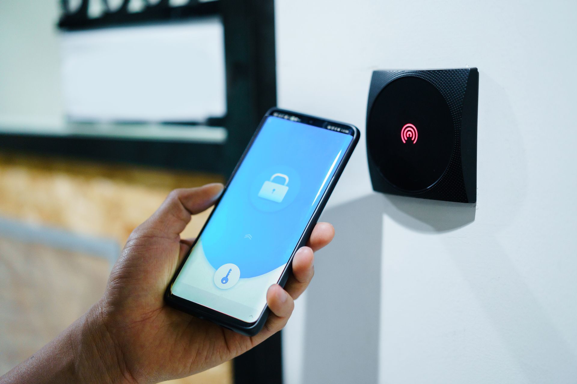 Unlocking home security with mobile phone.