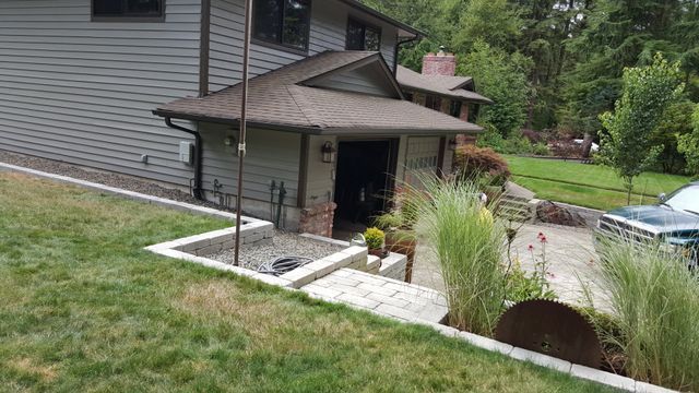 A house with a car parked in front of it.