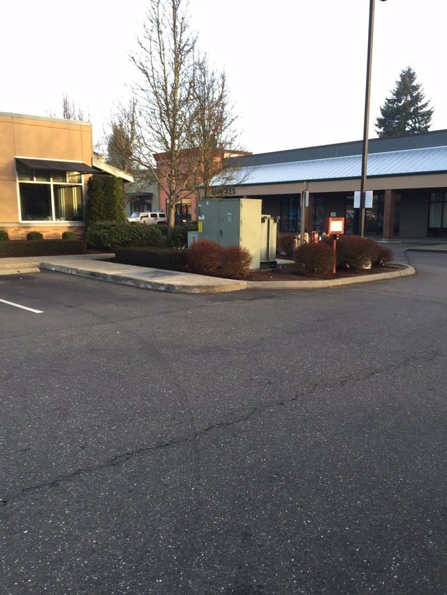 A parking lot with a building in the background