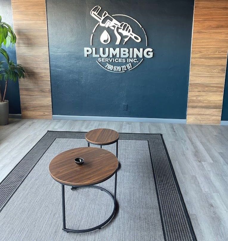 A room with two tables and a sign that says plumbing services inc.