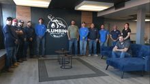A group of people are posing for a picture in a room.