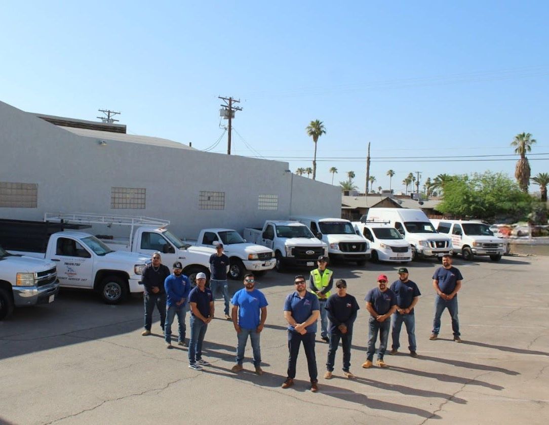 A group of men standing in front of a row of trucks.