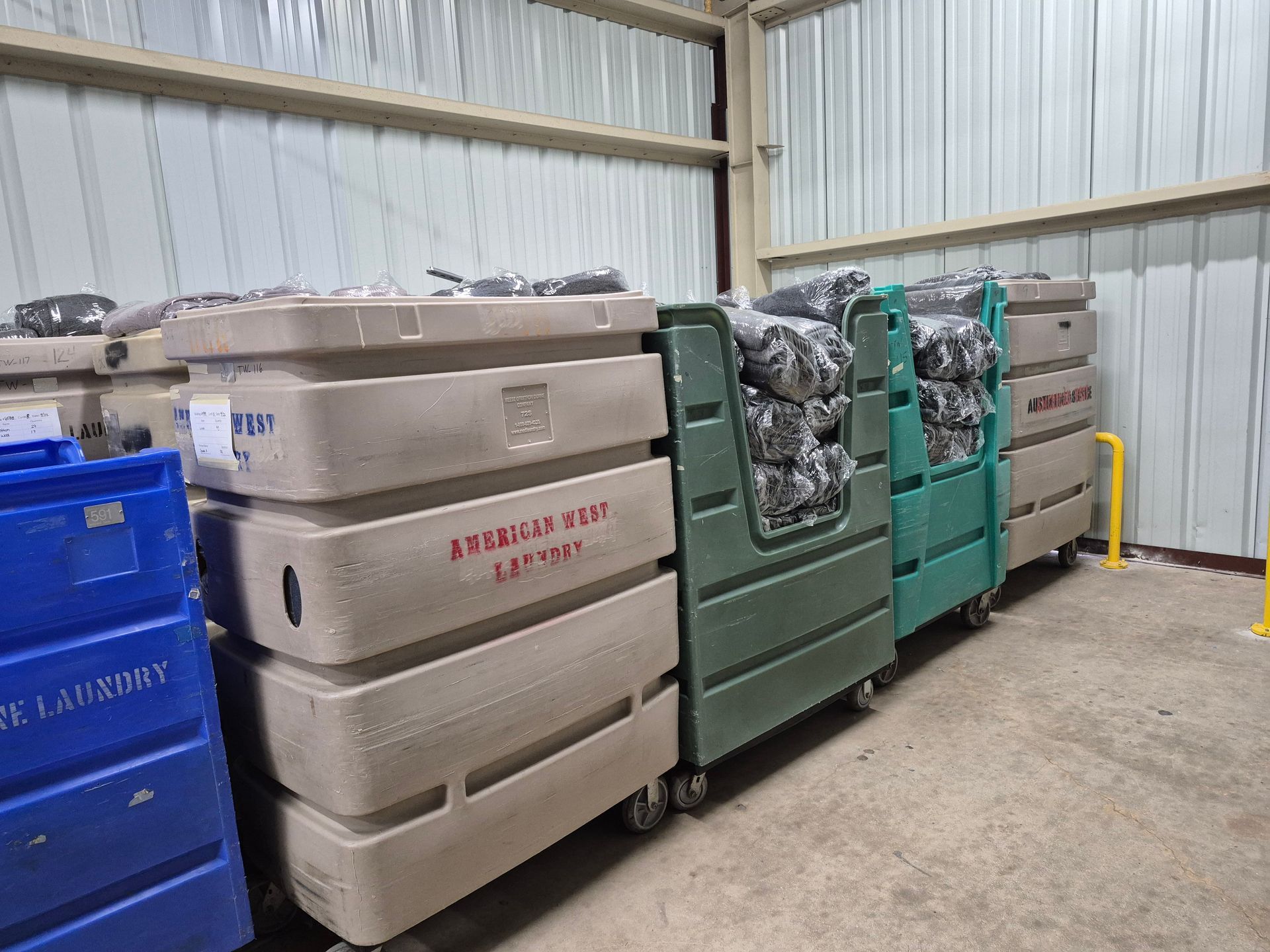 Hunter in camouflage, holding rifle, looking across a field at dawn.