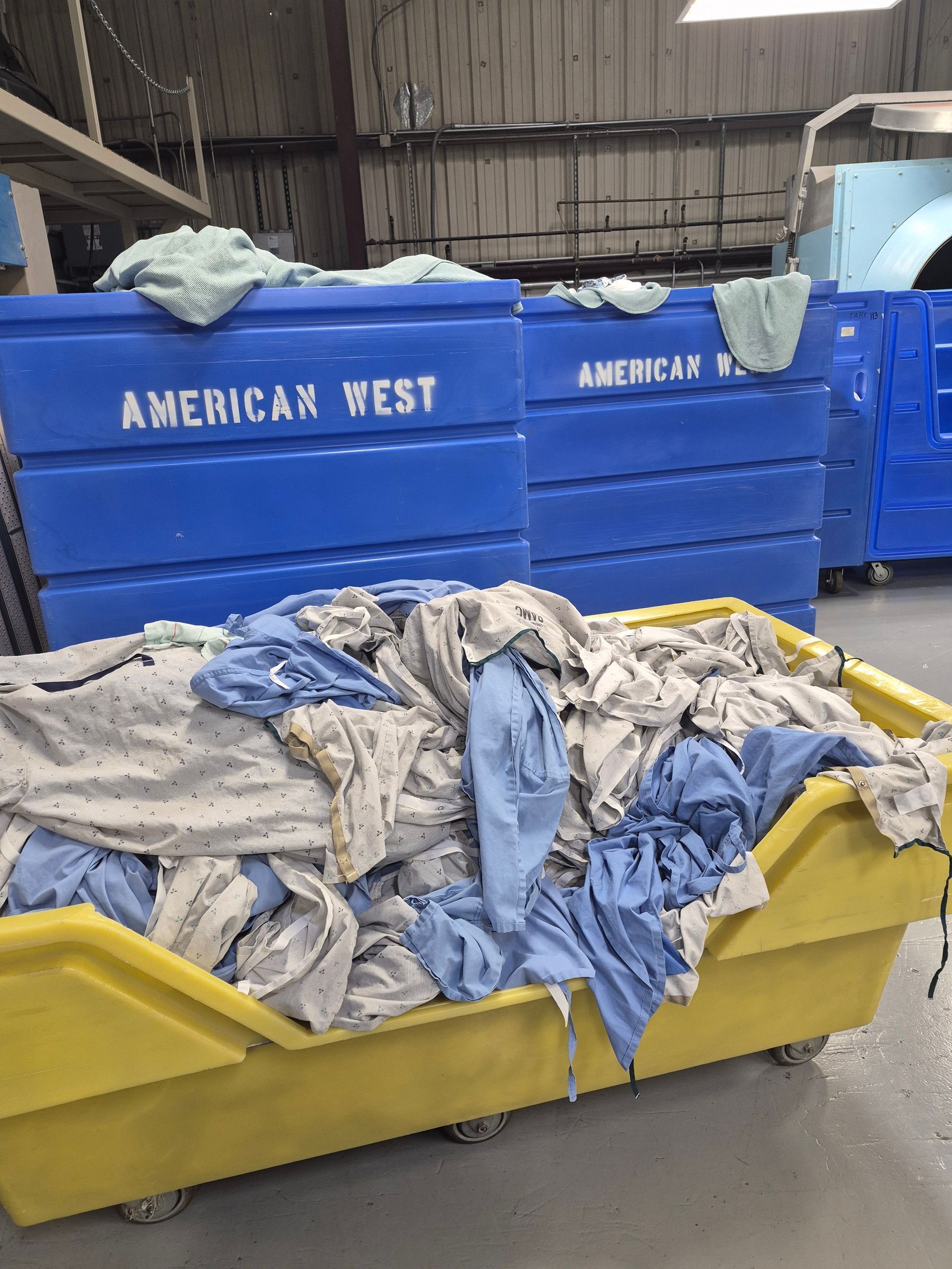 Laundry carts with blue bins labeled 