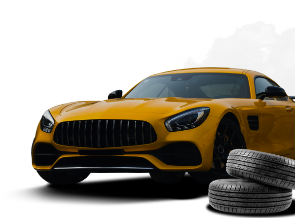 A yellow sports car is parked next to a pile of tires | Compassion Auto Care LLC