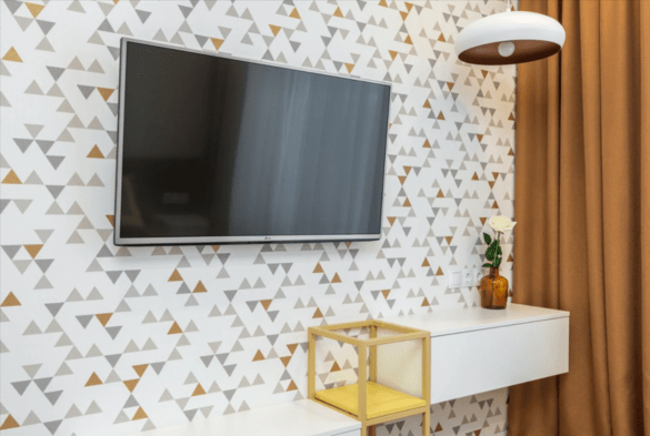 Wall mounted flat screen tv on decorative wall paper with concealed cords